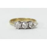 An 18ct three stone diamond ring, size M.