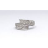 A 14ct white gold and diamond contemporary ring marked '585', set with baguette cut diamonds, size