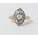 An 18ct Edwardian diamond cluster oval set ring, size M.