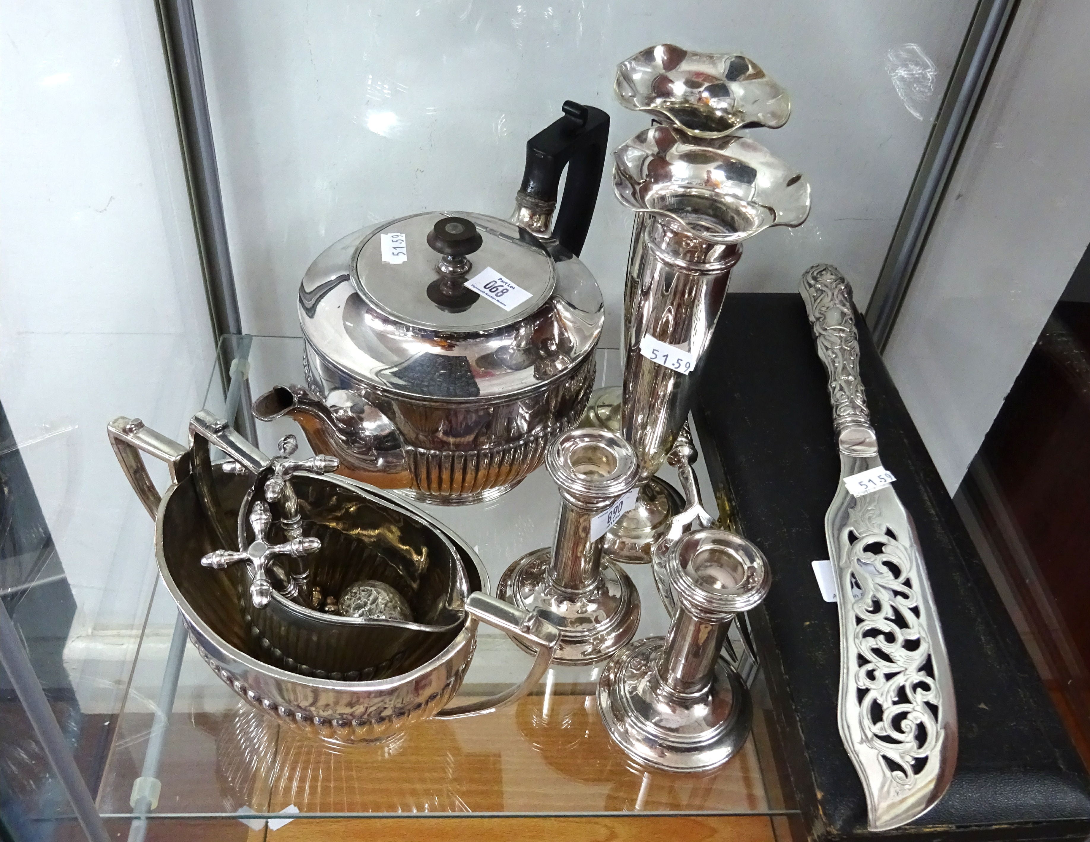 A pair of silver candlesticks, 10cm, a silver cane top, and a collection of various silver plated