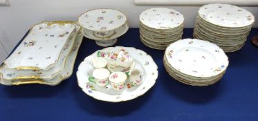 A 20th Century porcelain service decorated with flowers on white ground with a gilt border factory