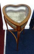 An Edwardian mahogany table cabinet (heart shaped) with marquetry inlay.