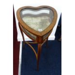 An Edwardian mahogany table cabinet (heart shaped) with marquetry inlay.