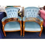 A pair of Edwardian upholstered armchairs with inlaid decoration one with replaced supports spelling