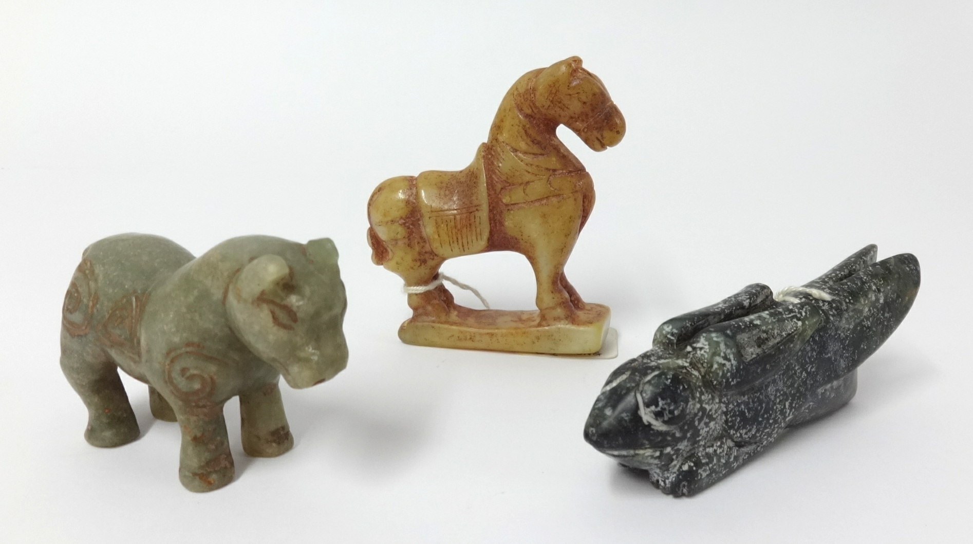 Three antique carvings including Chinese jade animal and two horse carvings, the tallest 8cm (3).