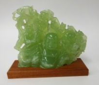 A carved 'jade' group depicting Buddha and laughing monkeys, height 18cm, width 22cm on later