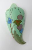 Clarice Cliff wall pocket decorated with stylised flowers and fruits on a green ground, height 32cm