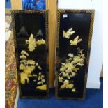 A pair of oriental lacquered wall panels decorated in relief with landscape, birds and flowers, 92 x