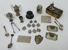 A silver cigarette case, a silver miniature clock case, miniature silver trophy cups, other metal