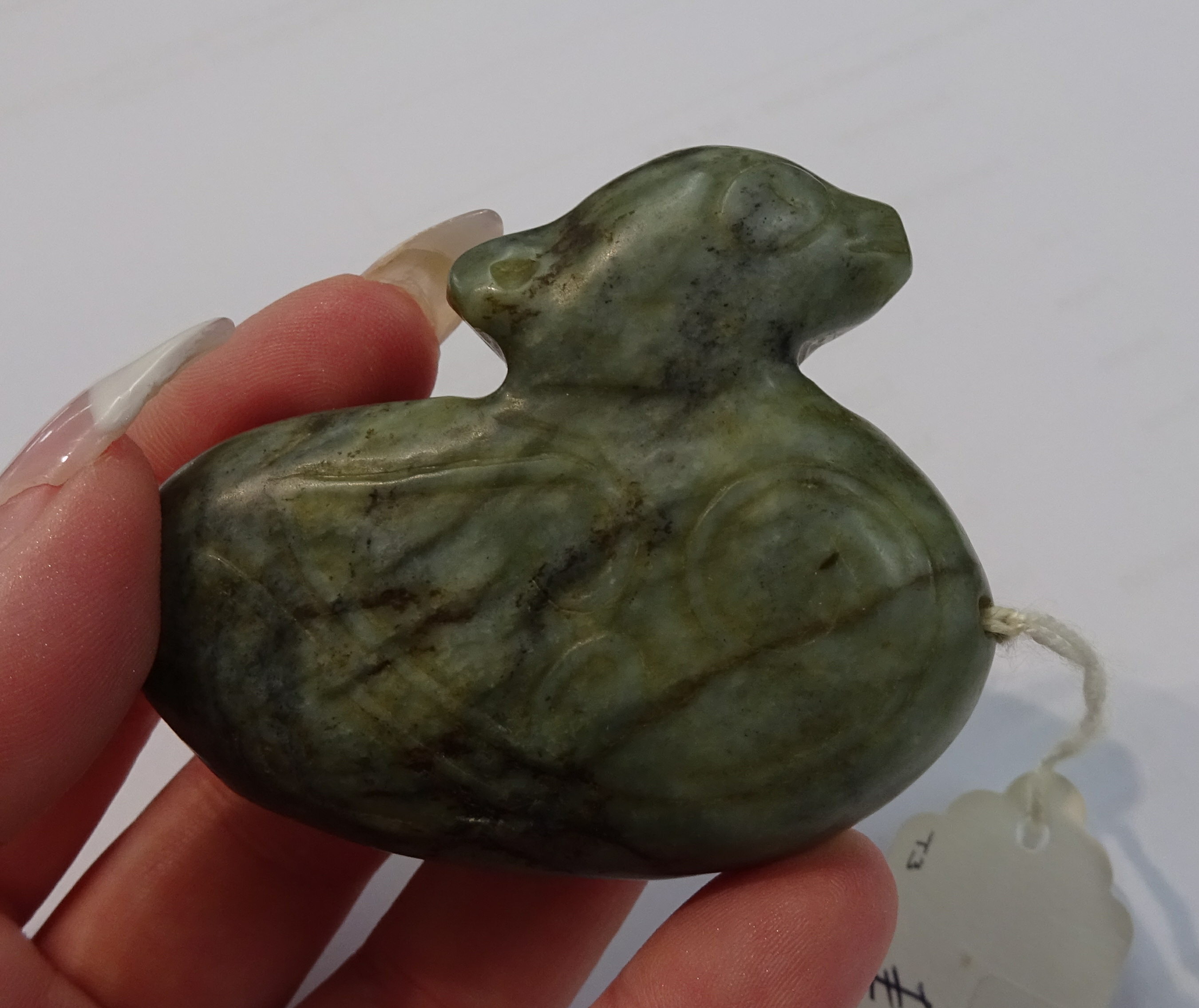 An oriental carved jade figure, a carved pig and dark green jade duck pendant, the tallest 7cm (3). - Image 9 of 10