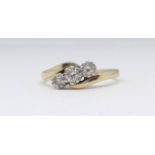 An 18ct three stone diamond ring, total diamond weight approx 0.33cts, size O.