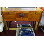 A narrow Chinese side table fitted with three drawers.