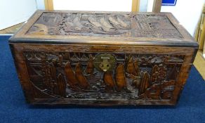 An oriental carved wood blanket chest