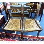 A pair of Regency side chairs with sabre legs, brass inlay and cane seats.