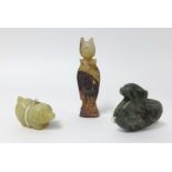 An oriental carved jade figure, a carved pig and dark green jade duck pendant, the tallest 7cm (3).