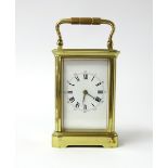 A French carriage clock the dial with roman numerals and outer ring of Arabic numerals, height 11cm,