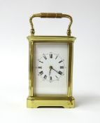 A French carriage clock the dial with roman numerals and outer ring of Arabic numerals, height 11cm,