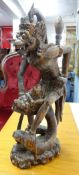 A carved wood eastern mythological figure, height 33cm.