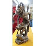 A carved wood eastern mythological figure, height 33cm.