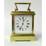 A heavy gauge brass carriage clock with gong striking movement the dial marked 'Howell James & Co,