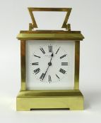 A heavy gauge brass carriage clock with gong striking movement the dial marked 'Howell James & Co,