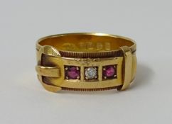 An 18ct buckle ring set with two ruby's and a diamond, 5.5gms.