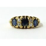An 18ct sapphire and diamond seven stone ring.