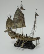 A Chinese silver boat model marked Tack Hing, silver on carved wood stand height 20cm.