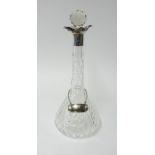 A glass decanter with silver mount height 34cm.