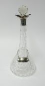 A glass decanter with silver mount height 34cm.