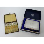 A set of six 1935 silver jubilee tea spoons cased together with a QEII 1970 jubilee EPNS cigarette