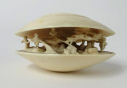 A carved ivory clam dream shell signed on the base. 7 x 5 x 4 cm.