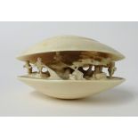 A carved ivory clam dream shell signed on the base. 7 x 5 x 4 cm.