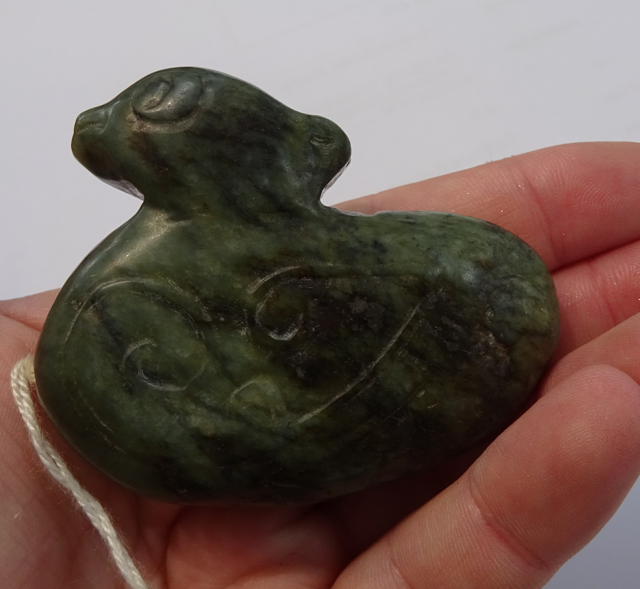 An oriental carved jade figure, a carved pig and dark green jade duck pendant, the tallest 7cm (3). - Image 2 of 10