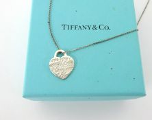 A Tiffany & Co. silver heart pendant, boxed.