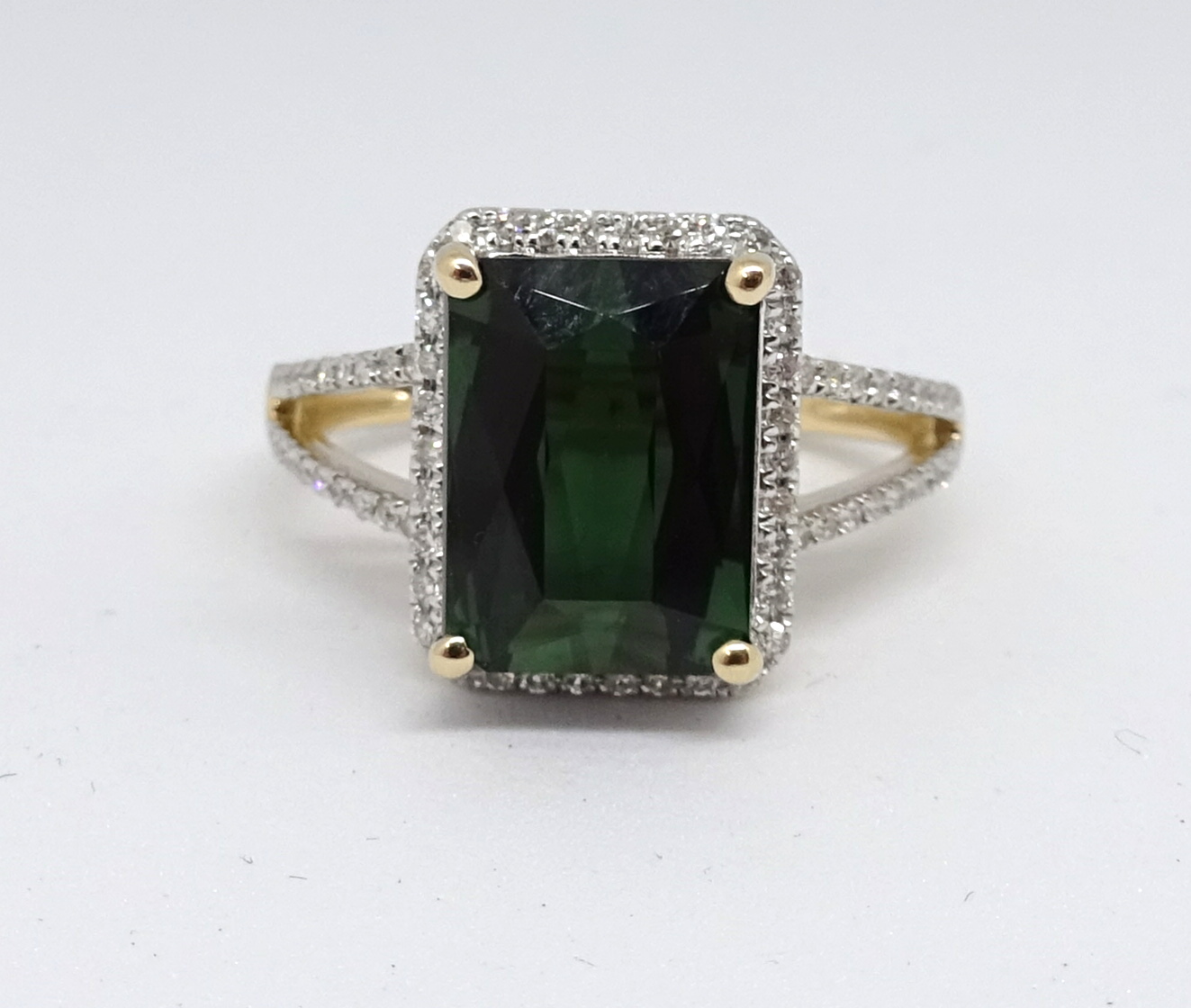 A 14ct yellow gold and diamond ring set with an emerald cut green tourmaline, approx. 3.97carat,