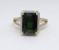 A 14ct yellow gold and diamond ring set with an emerald cut green tourmaline, approx. 3.97carat,