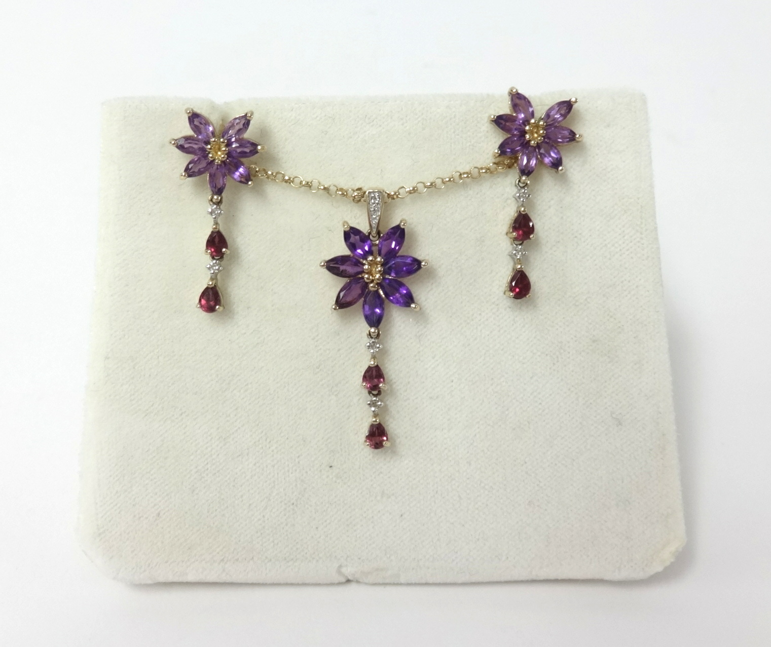 An amethyst, ruby and diamond set of jewellery, total weight 7.9gms.