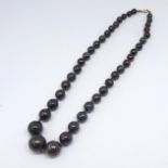 A black opal bead necklace, with graduated beads length 38cm.