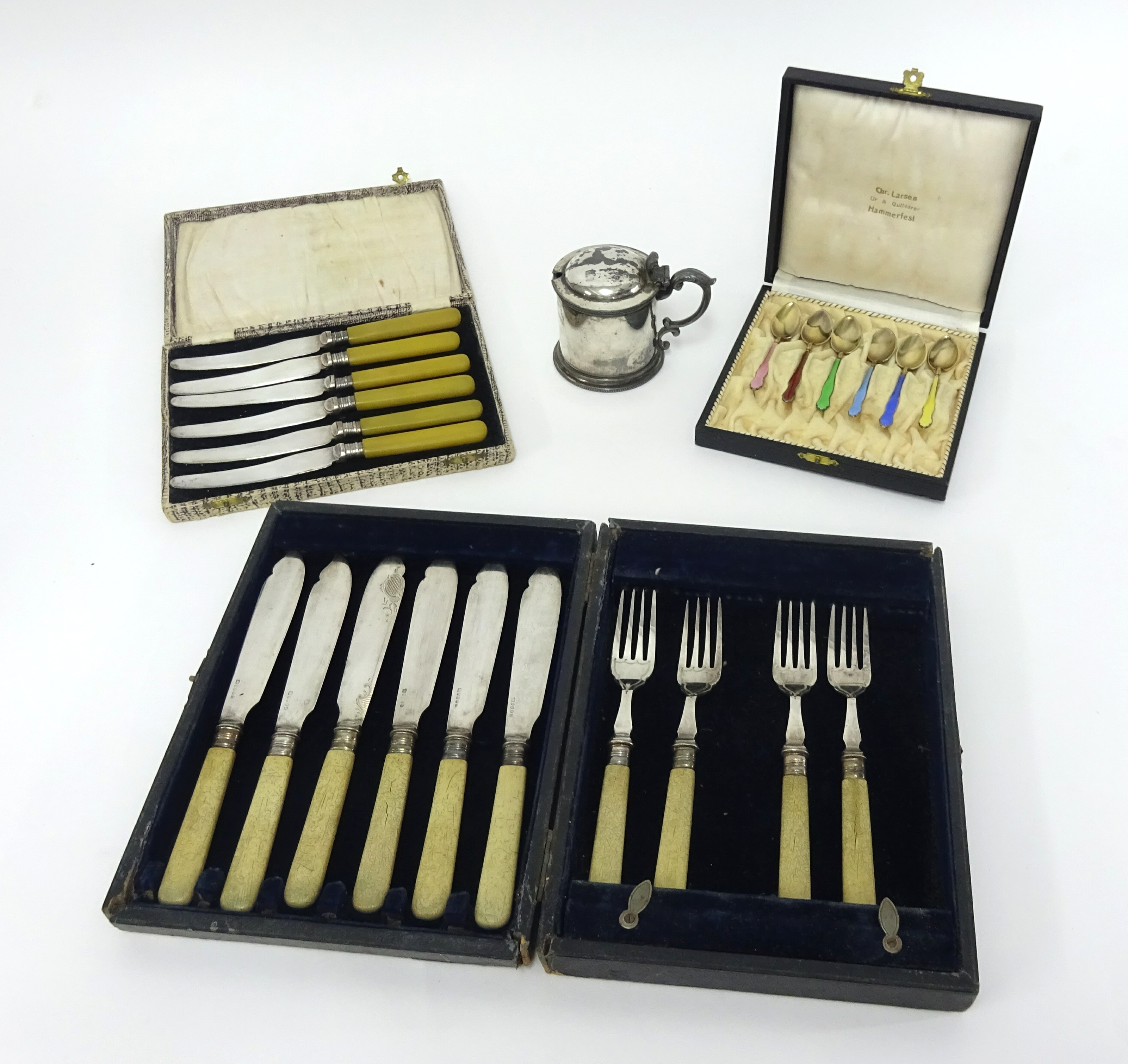 A set of six enamelled Dutch? Silver teaspoons cased, together with plated cased fish set knives