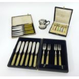 A set of six enamelled Dutch? Silver teaspoons cased, together with plated cased fish set knives