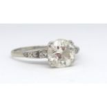 A platinum and diamond solitaire ring set with a single old cut diamond approx. 2.10 carats on a