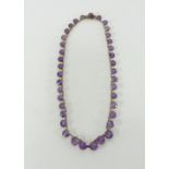 An amethyst and gold necklace, length approx. 39cm.