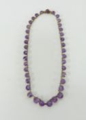 An amethyst and gold necklace, length approx. 39cm.