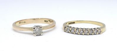 A 9ct diamond solitaire ring, size I and a 9ct half band and diamond set eternity ring (2).