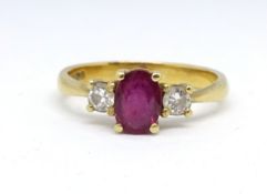 A 18ct ruby and diamond three stone ring, size M.