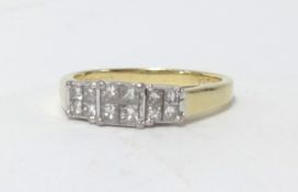 An 18ct diamond ring set with 12 princess cut diamonds, marked '0.33carat', size L.