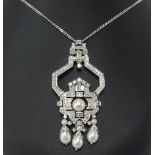 An art deco style diamond and pearl pendant and chain, set within an arrangement of round and