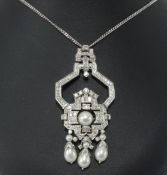 An art deco style diamond and pearl pendant and chain, set within an arrangement of round and