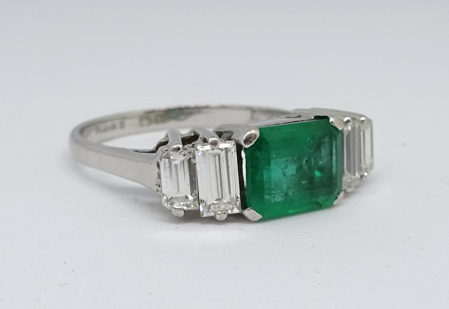 An 18ct emerald and diamond ring, set with baguette cut diamonds in a claw setting, the emerald 7. - Image 2 of 2